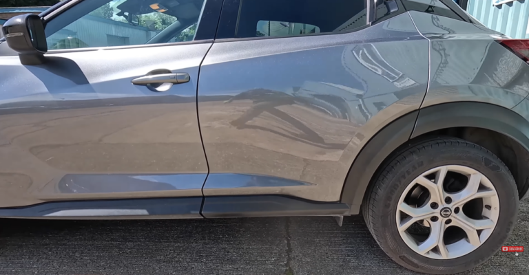 Car panel after paintless dent repair — dent completely removed