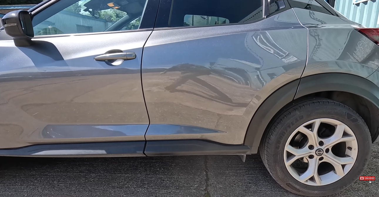 Car panel after paintless dent repair — dent completely removed