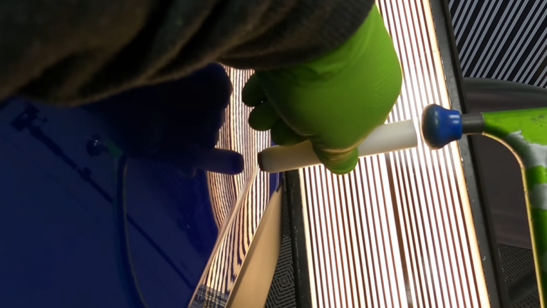 PDR technician performing paintless dent repair on vehicle
