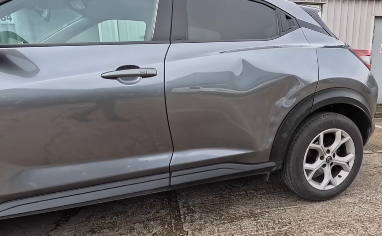 Car hood with dents before paintless dent repair Las Vegas