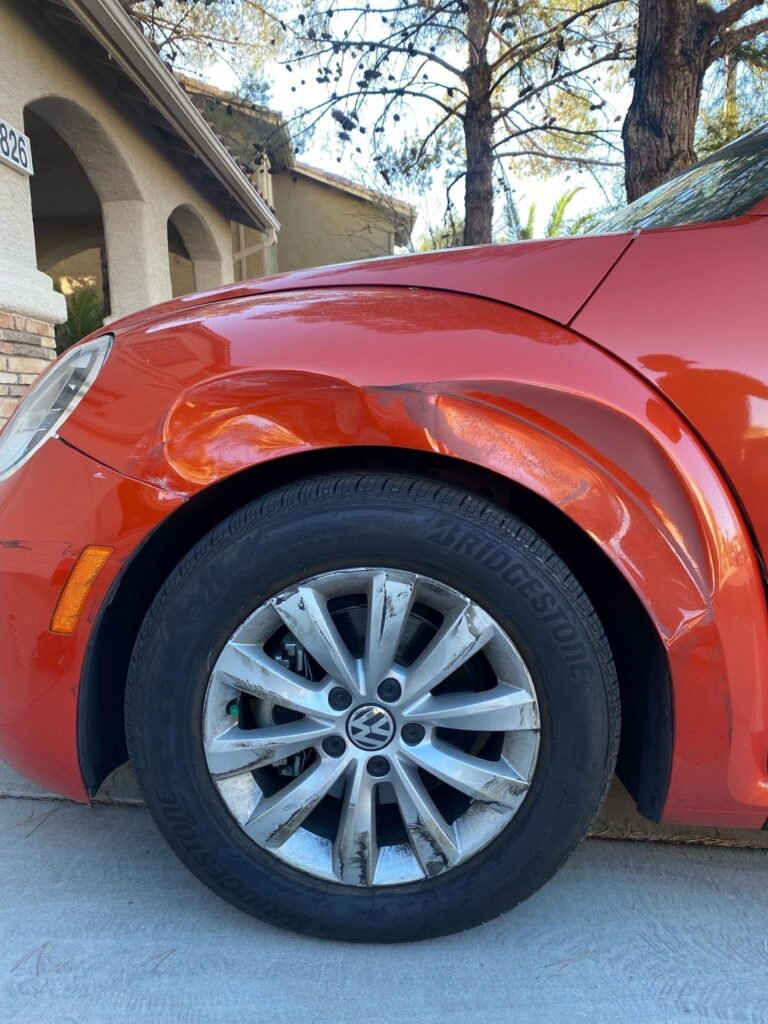 Vehicle door with door ding before paintless dent repair Henderson